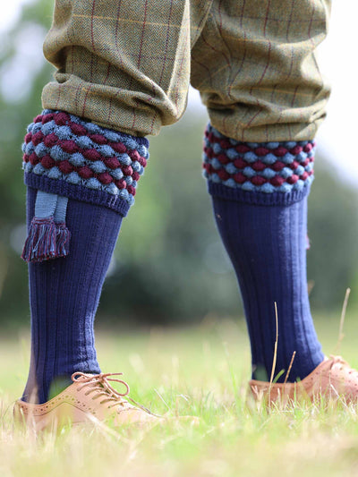 Navy blue shooting Sock with PomPom knit turnover featuring burgundy and pale blue pattern.