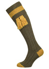 Green long knitted shooting socks with pollen gold pattern in the turnover top