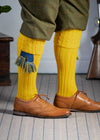 Long knitted shooting socks with a cable turnover in a bright canary yellow.