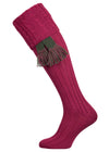 Long knitted shooting socks with a cable turnover in a deep pink purple.