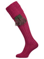 Long knitted shooting socks with a cable turnover in a deep pink purple.