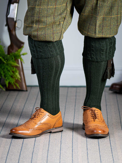 Long knitted shooting socks with a cable turnover in a very dark green.