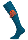Long knitted shooting socks with a cable turnover in a rich teal petrol blue.