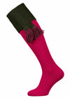 Bright pink shooting sock with dark green turnover and optional dark green garter tie