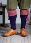 Long knitted shooting socks with a ribbed leg. Dark purple with a deep pink and camel pattern in the turnover top.