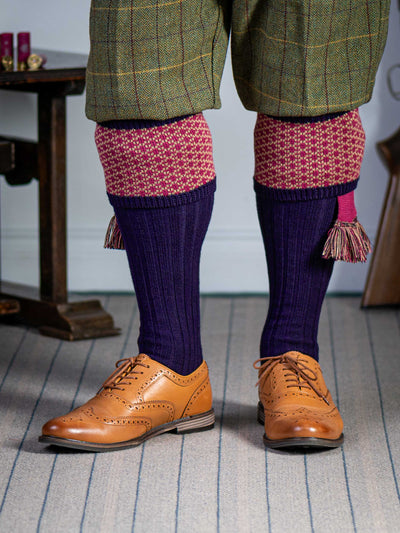 Long knitted shooting socks with a ribbed leg. Dark purple with a deep pink and camel pattern in the turnover top.