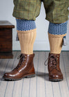 Long knitted shooting socks with a ribbed leg. Beige with a navy and sky blue pattern in the turnover top.