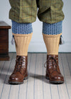 Long knitted shooting socks with a ribbed leg. Beige with a navy and sky blue pattern in the turnover top.