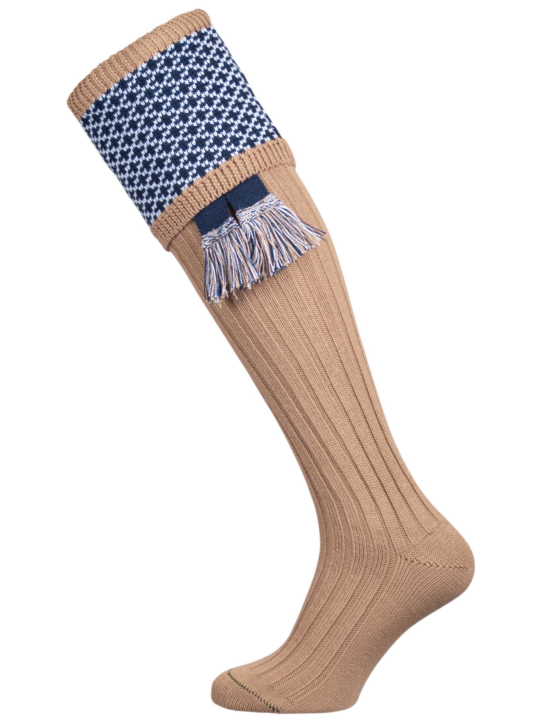 Long knitted shooting socks with a ribbed leg. Beige with a navy and sky blue pattern in the turnover top.