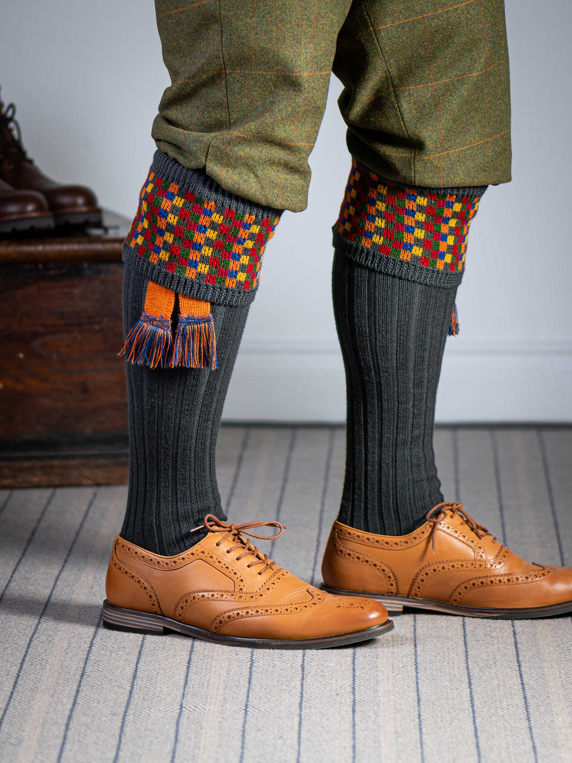Long dark grey knitted shooting socks with a ribbed leg, features 8 different colours in the pattern turnover top.