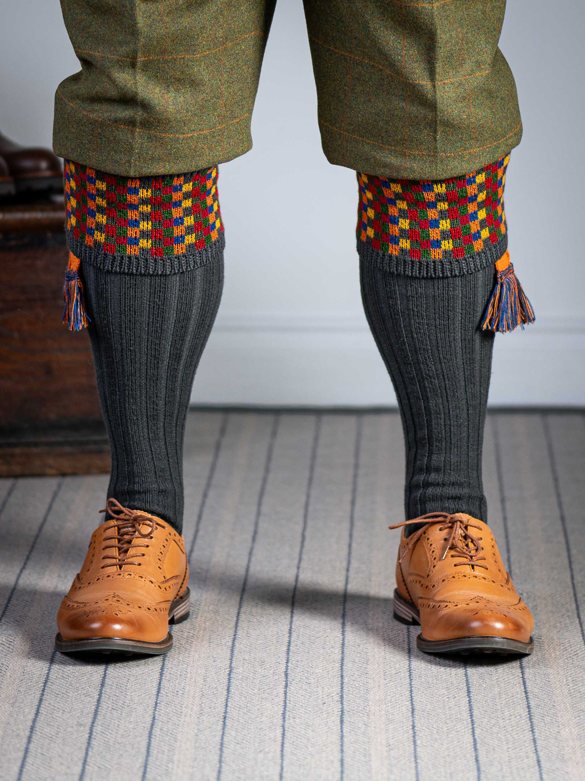 Long dark grey knitted shooting socks with a ribbed leg, features 8 different colours in the pattern turnover top.