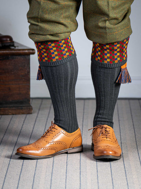 Long dark grey knitted shooting socks with a ribbed leg, features 8 different colours in the pattern turnover top.