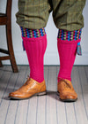 Long knitted shooting socks in bright pink with a ribbed leg, features 8 different colours in the pattern turnover top.