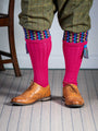 Long knitted shooting socks in bright pink with a ribbed leg, features 8 different colours in the pattern turnover top.