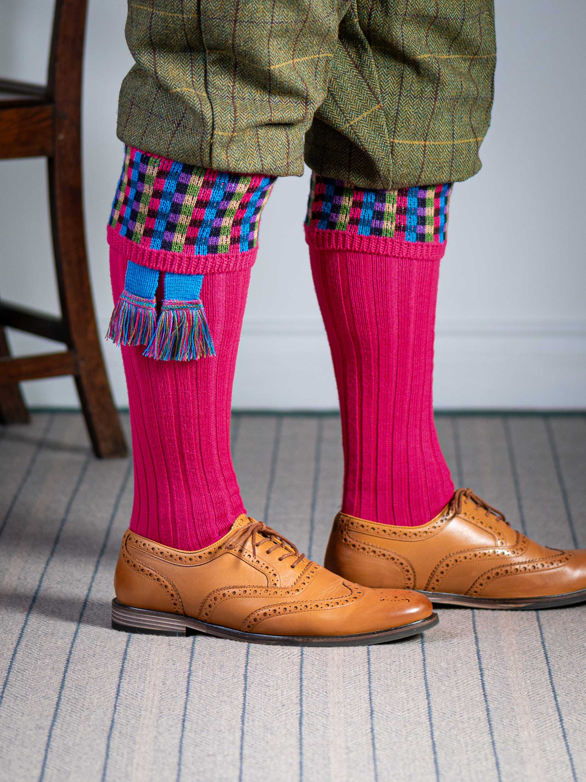 Long knitted shooting socks in bright pink with a ribbed leg, features 8 different colours in the pattern turnover top.