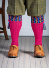 Long knitted shooting socks in bright pink with a ribbed leg, features 8 different colours in the pattern turnover top.