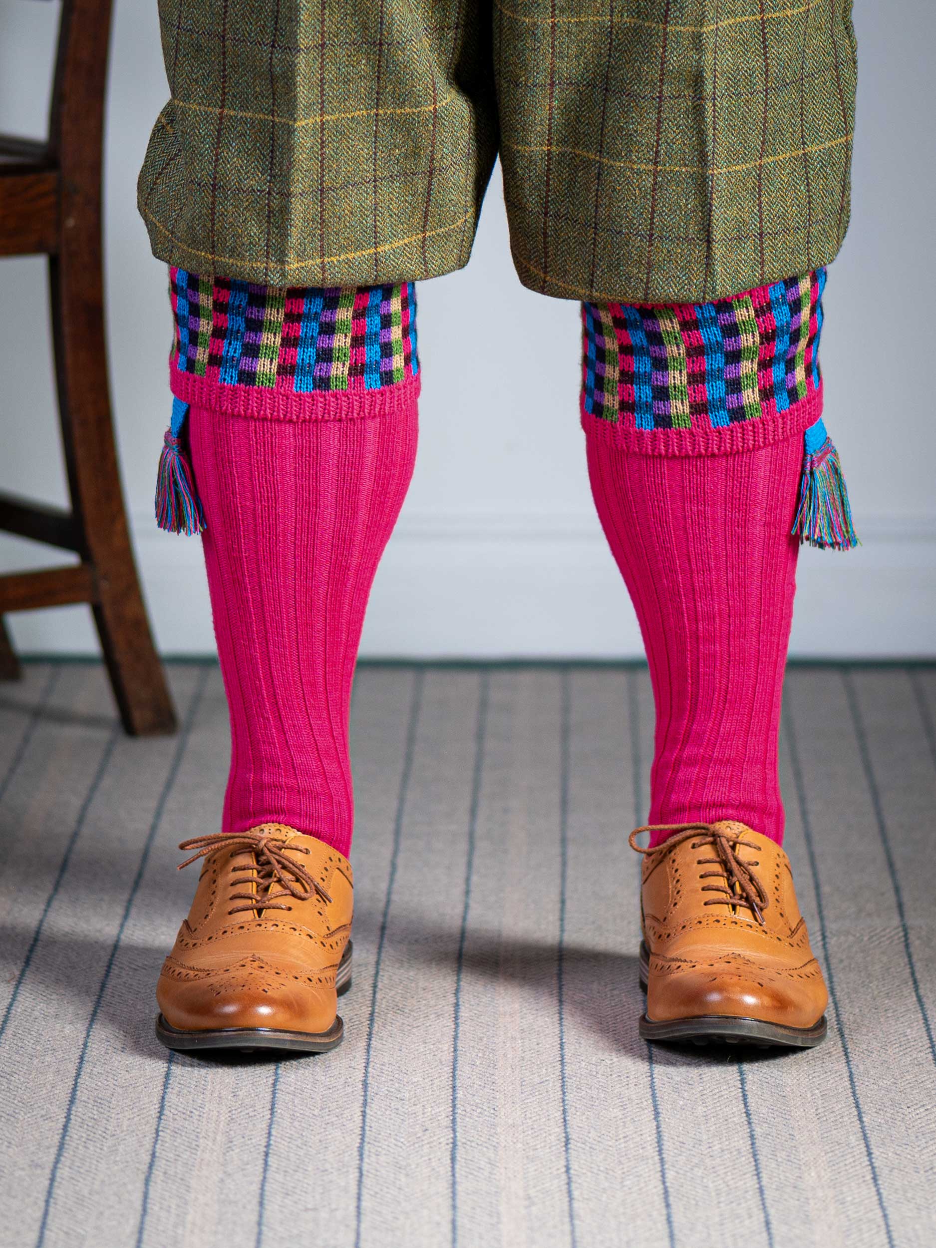 Long knitted shooting socks in bright pink with a ribbed leg, features 8 different colours in the pattern turnover top.