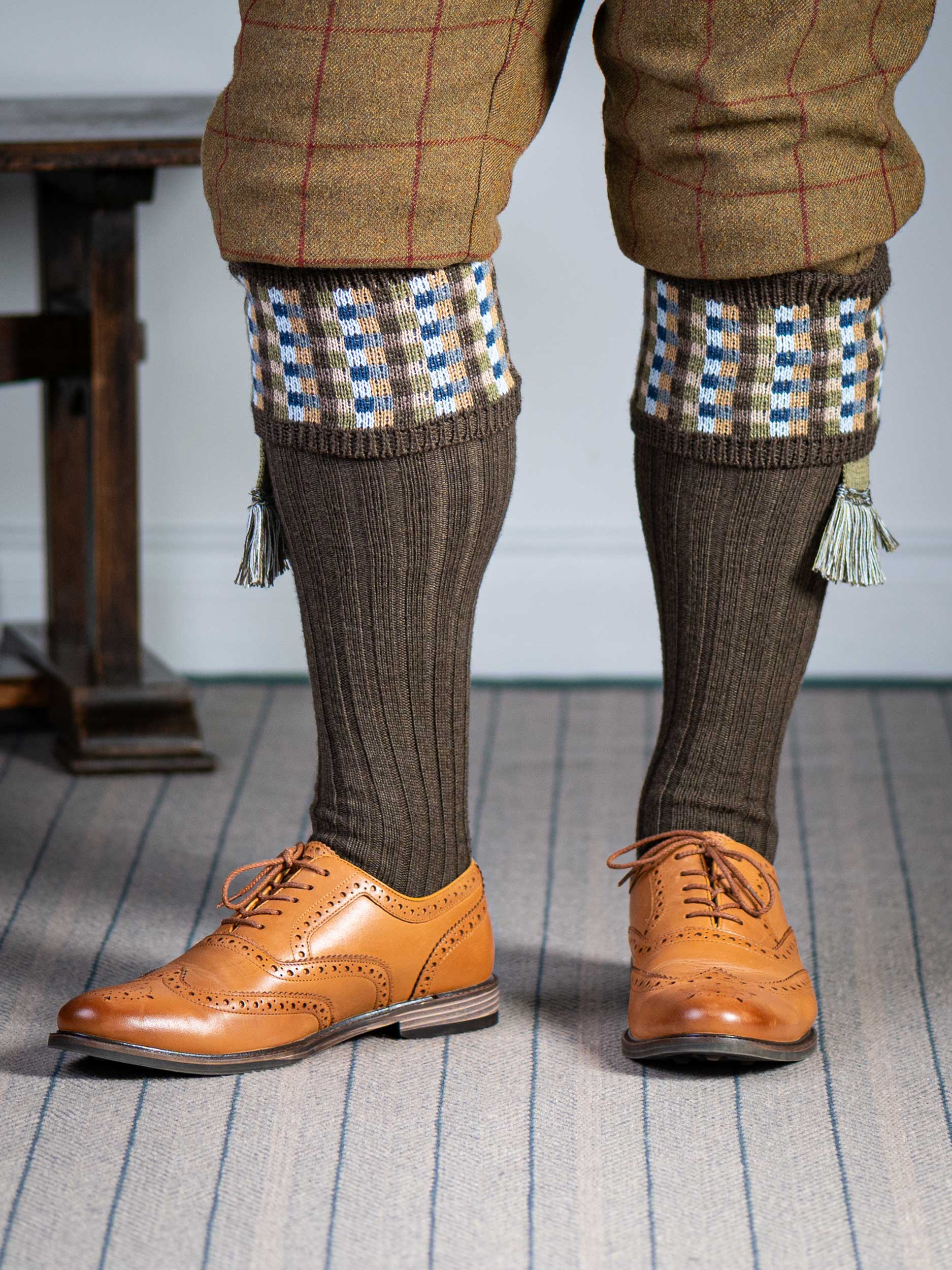 Long knitted shooting socks in earthy brown with a ribbed leg, features 8 different colours in the pattern turnover top.