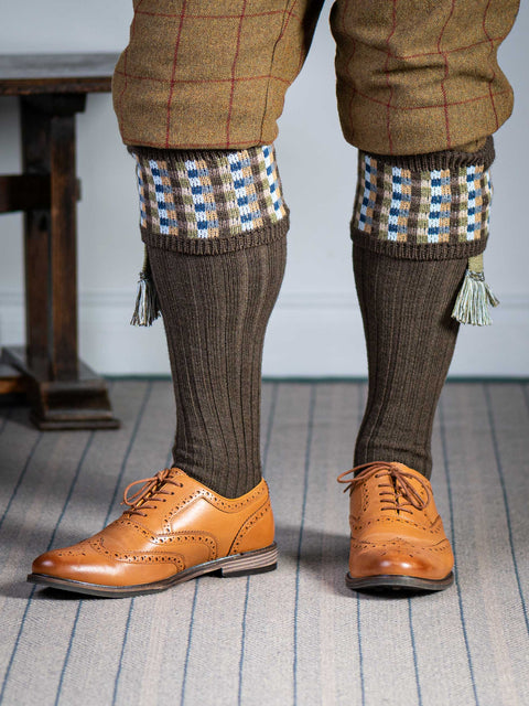 Long knitted shooting socks in earthy brown with a ribbed leg, features 8 different colours in the pattern turnover top.