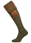 Traditional knitted shooting socks with a chessboard pattern in the turnover, in green and gold.