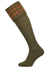 Traditional knitted shooting socks with a chessboard pattern in the turnover, in green and gold.