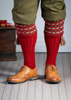 Traditional knitted shooting socks with a textured knitted top in brick red with green and beige pattern.