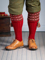 Traditional knitted shooting socks with a textured knitted top in brick red with green and beige pattern.
