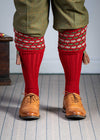 Traditional knitted shooting socks with a textured knitted top in brick red with green and beige pattern.