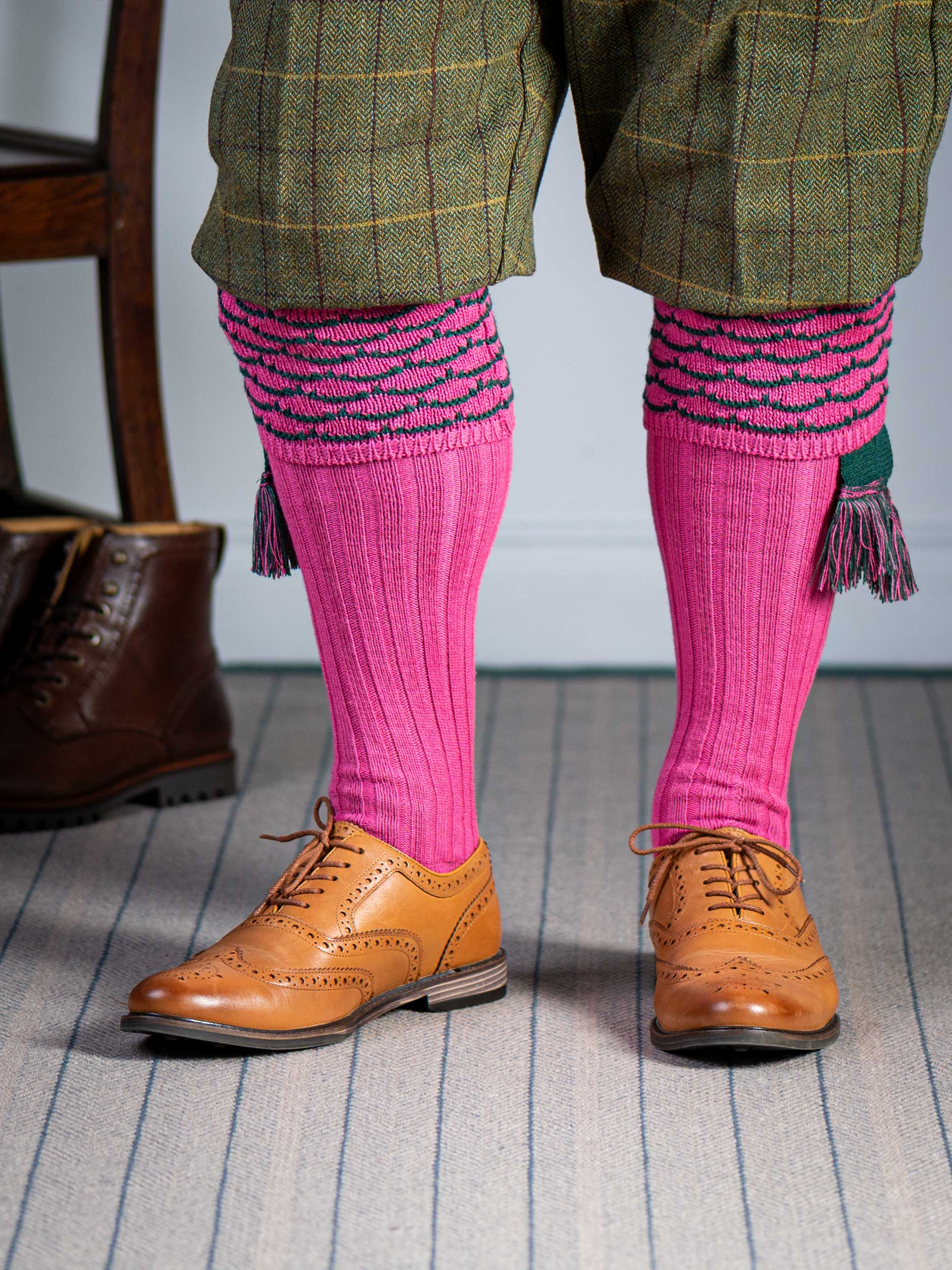 Traditional knitted shooting socks with ribbed leg in pink with a green scallop stitch detail in the turnover top