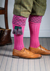 Traditional knitted shooting socks with ribbed leg in pink with a green scallop stitch detail in the turnover top