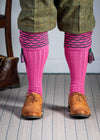 Traditional knitted shooting socks with ribbed leg in pink with a green scallop stitch detail in the turnover top