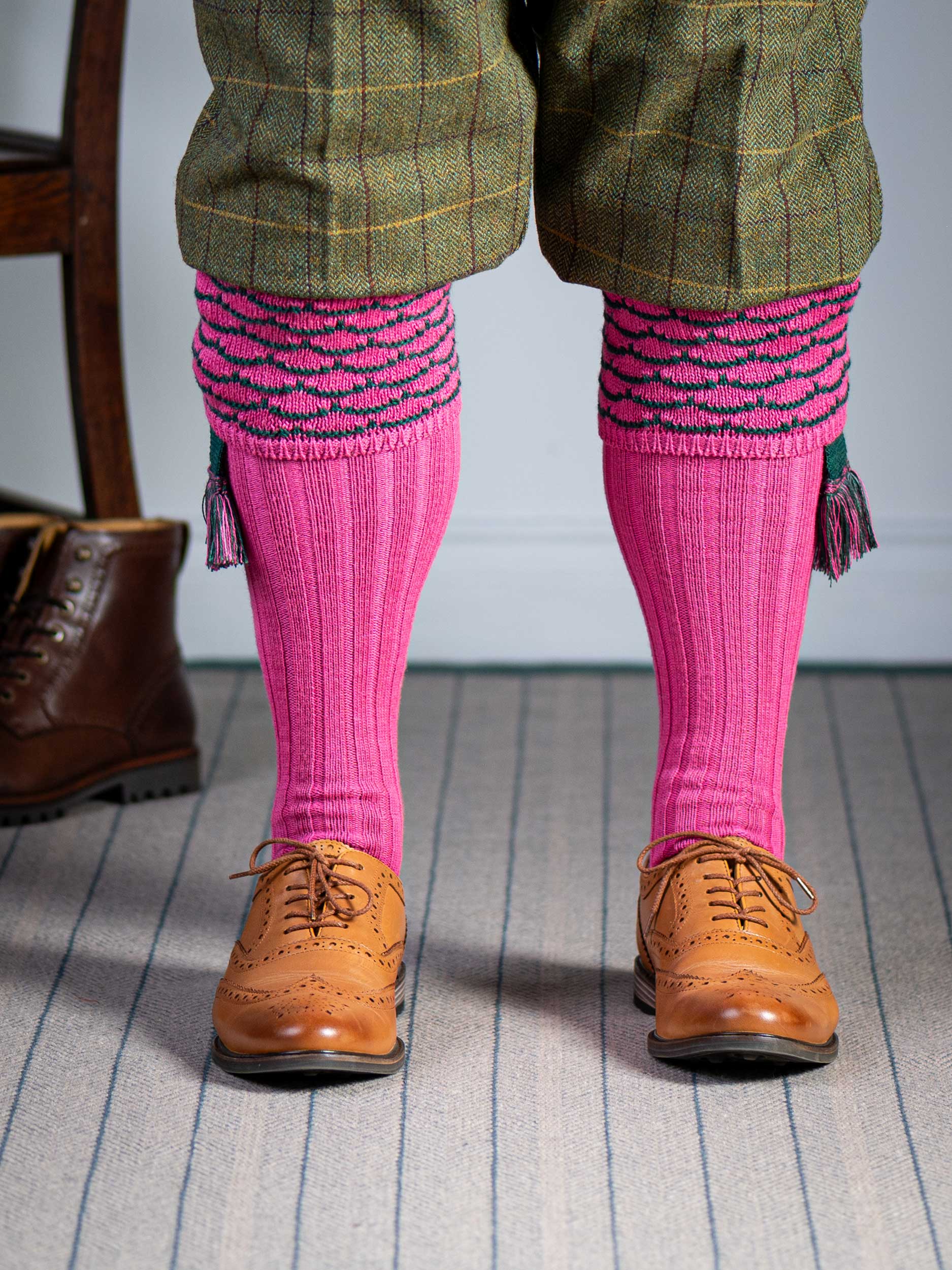 Traditional knitted shooting socks with ribbed leg in pink with a green scallop stitch detail in the turnover top