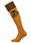 Full length gold knitted sock with pattern turnover and optional green garter tie.