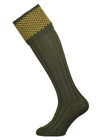 Wool shooting sock in green with a gold knitted pattern in the cuff