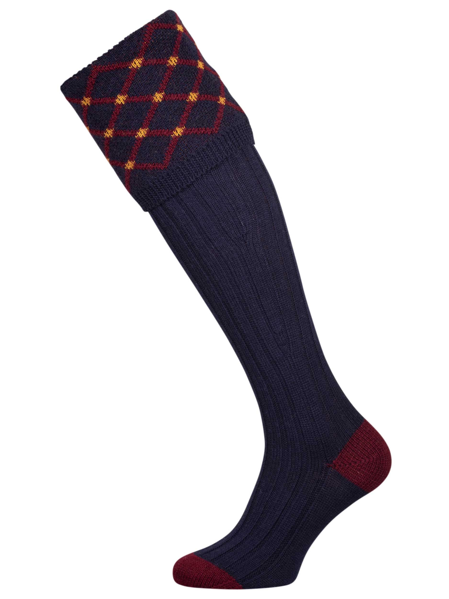 Merino wool shooting sock in navy blue with a gold and burgundy pattern knitted in the turnover