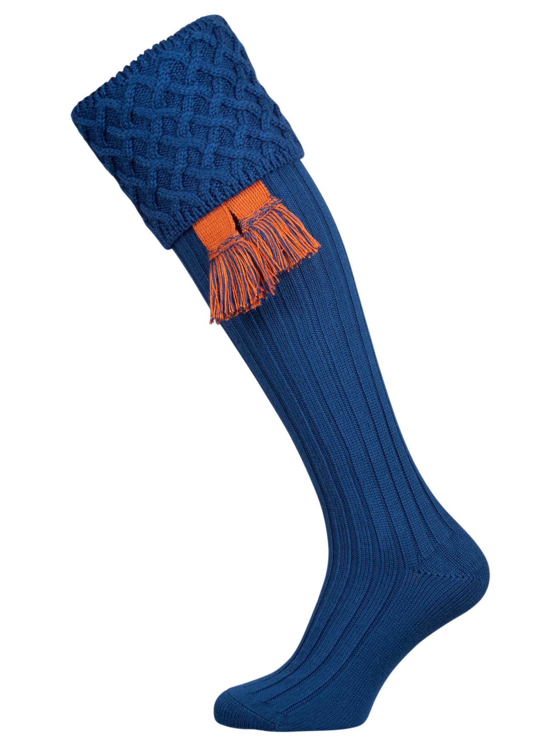 Traditional knitted shooting socks with ribbed leg in mid blue with a lattice knit pattern in the turnover