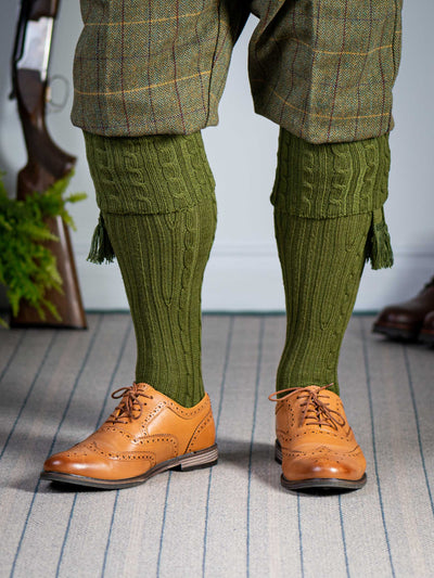 Knitted shooting socks with cable pattern though the leg and the turnover in khaki green