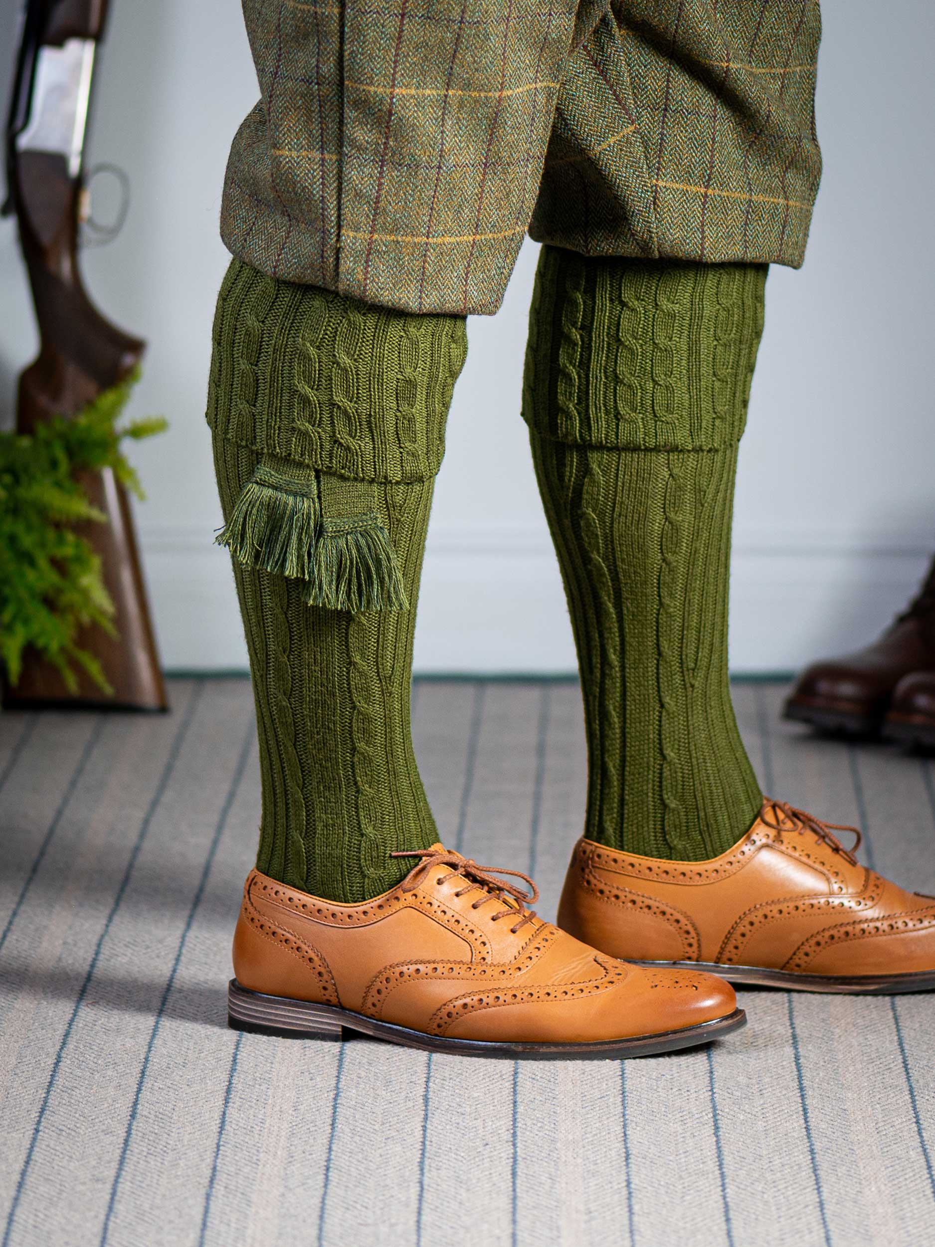 Knitted shooting socks with cable pattern though the leg and the turnover in khaki green