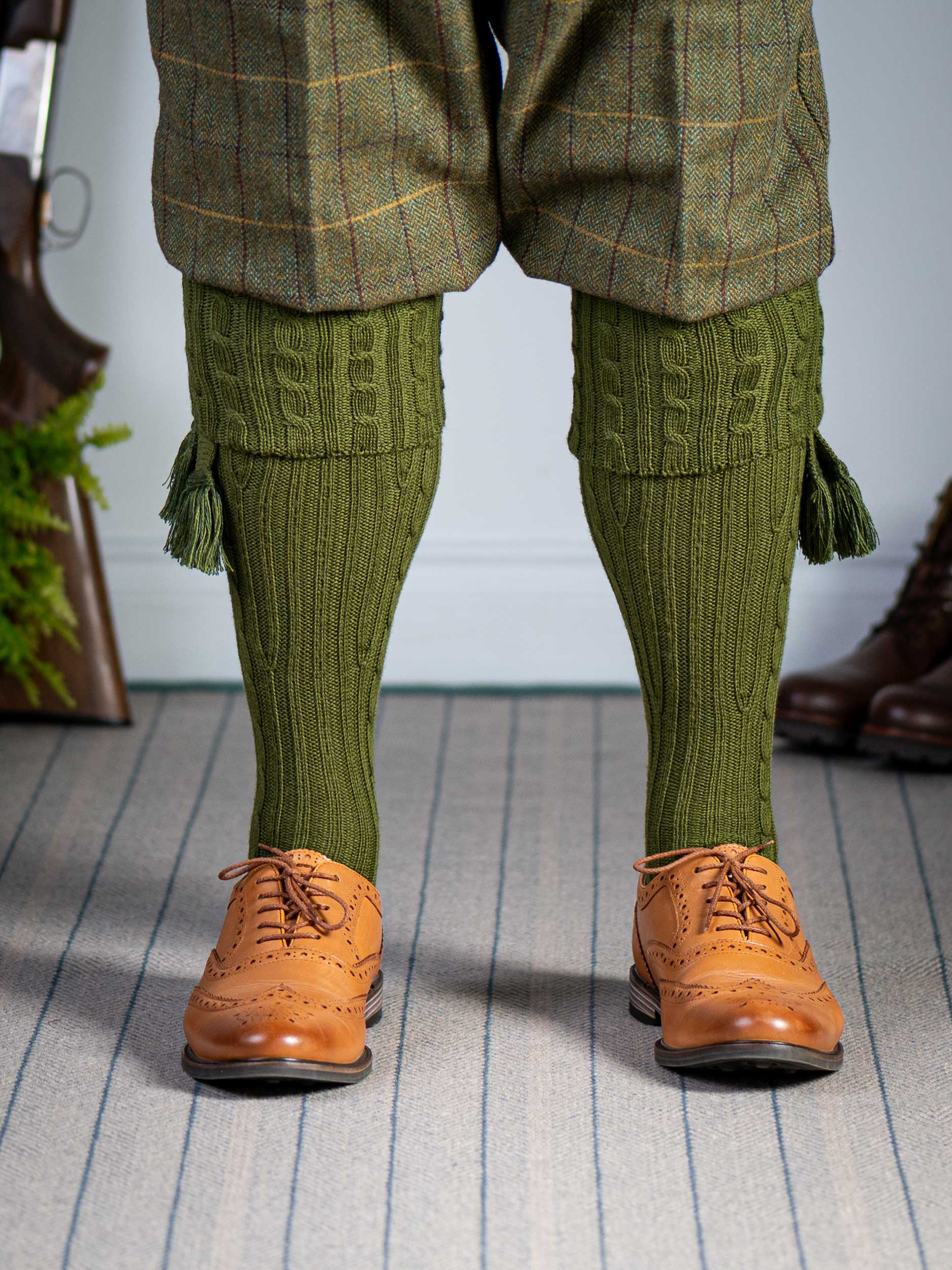 Knitted shooting socks with cable pattern though the leg and the turnover in khaki green