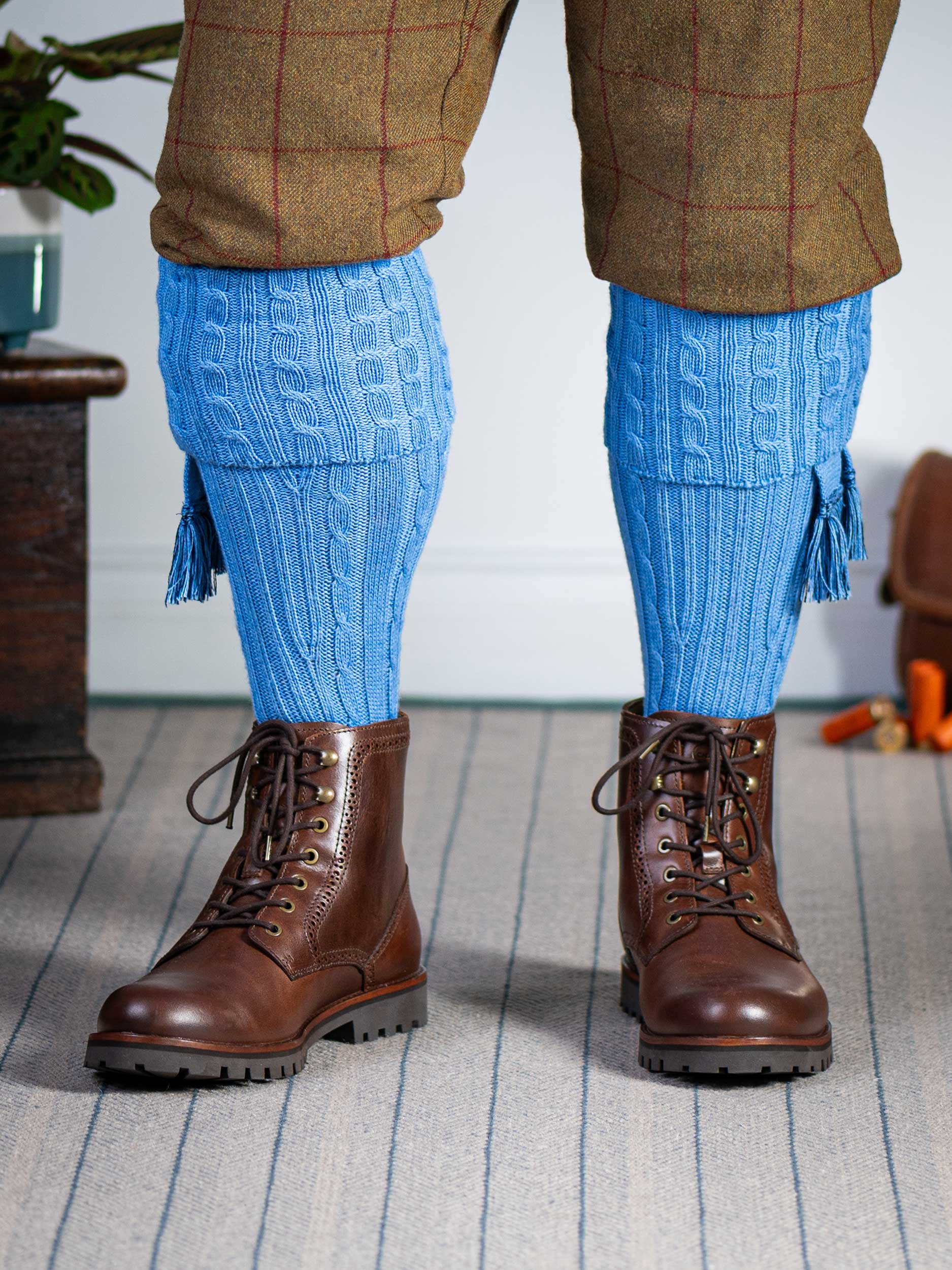 Knitted shooting socks with cable pattern though the leg and the turnover in sky blue
