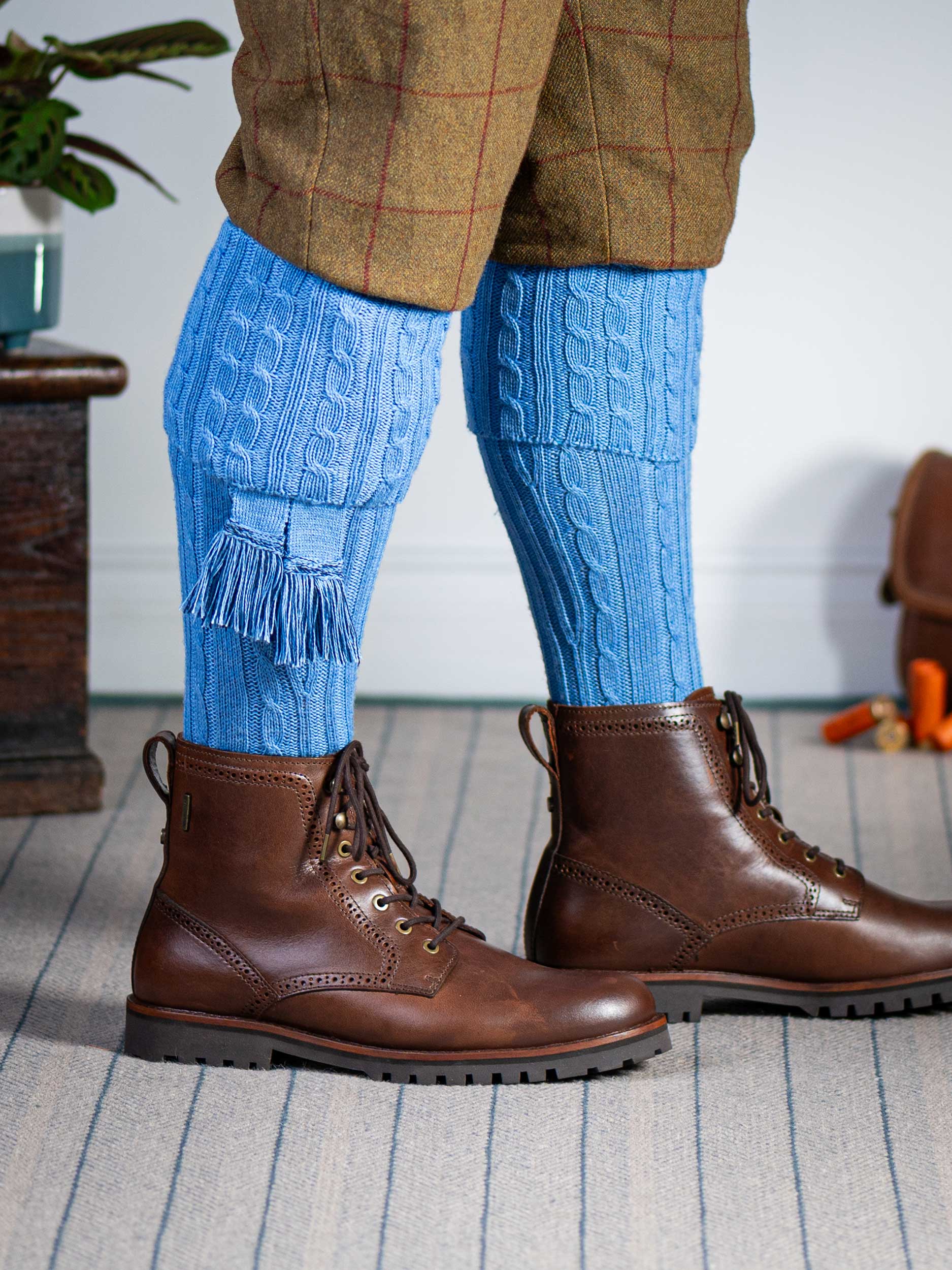 Knitted shooting socks with cable pattern though the leg and the turnover in sky blue