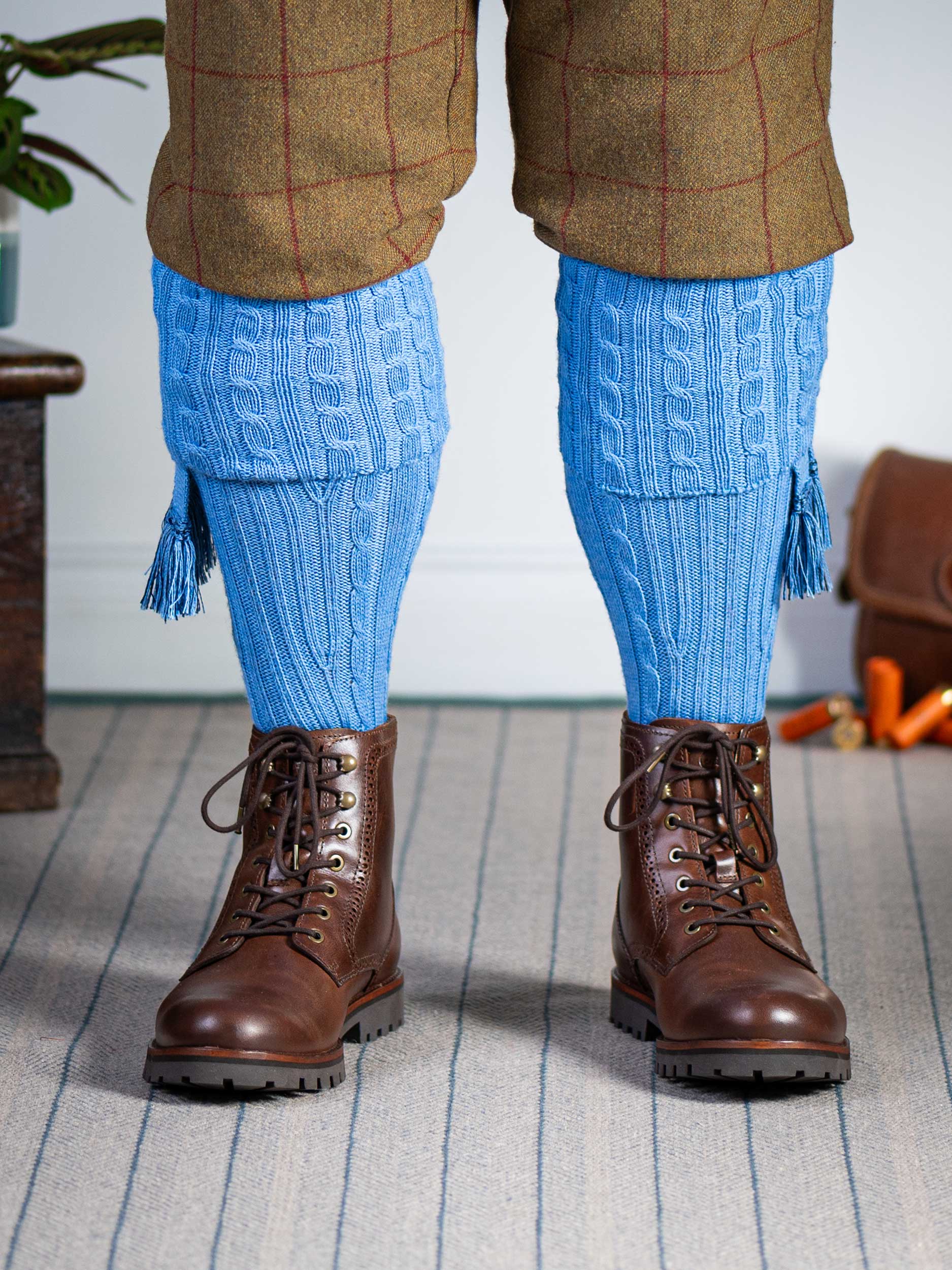 Knitted shooting socks with cable pattern though the leg and the turnover in sky blue