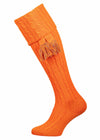 Bright orange knee high socks with cable detail in the leg. Optional co-ordinating garter.