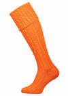 Bright orange knee high socks with cable detail in the leg.