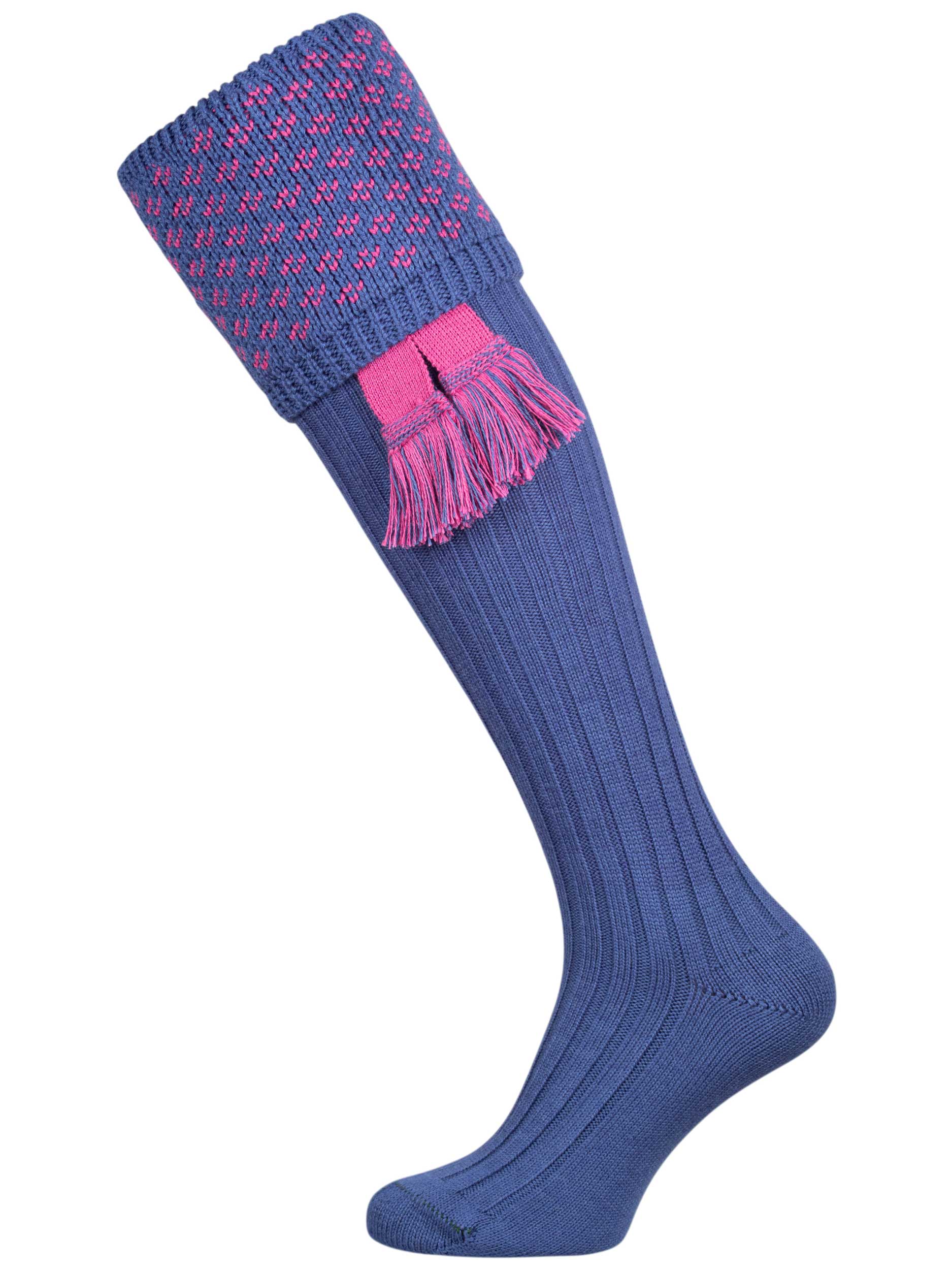 A subtle patterned shooting sock, featuring a denim blue ribbed leg with a dusky pink knitted pattern in the turnover