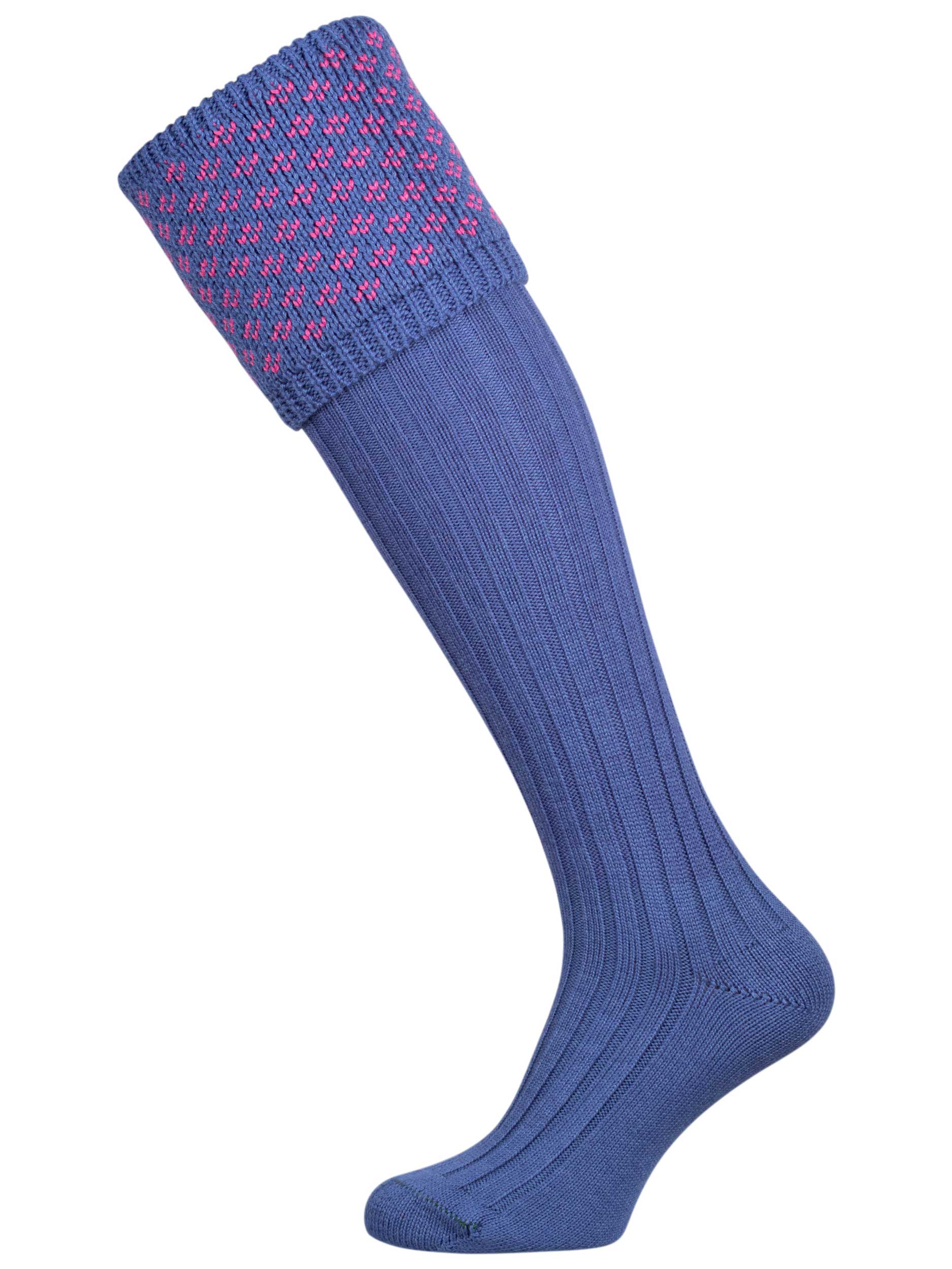 A subtle patterned shooting sock, featuring a denim blue ribbed leg with a dusky pink knitted pattern in the turnover