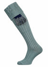A plain cotton shooting sock with knitted cable detail in lovat green, and an optional navy blue garter tie