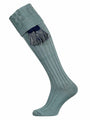 A plain cotton shooting sock with knitted cable detail in lovat green, and an optional navy blue garter tie