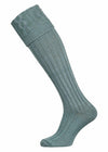 A plain cotton shooting sock with knitted cable detail in lovat green.