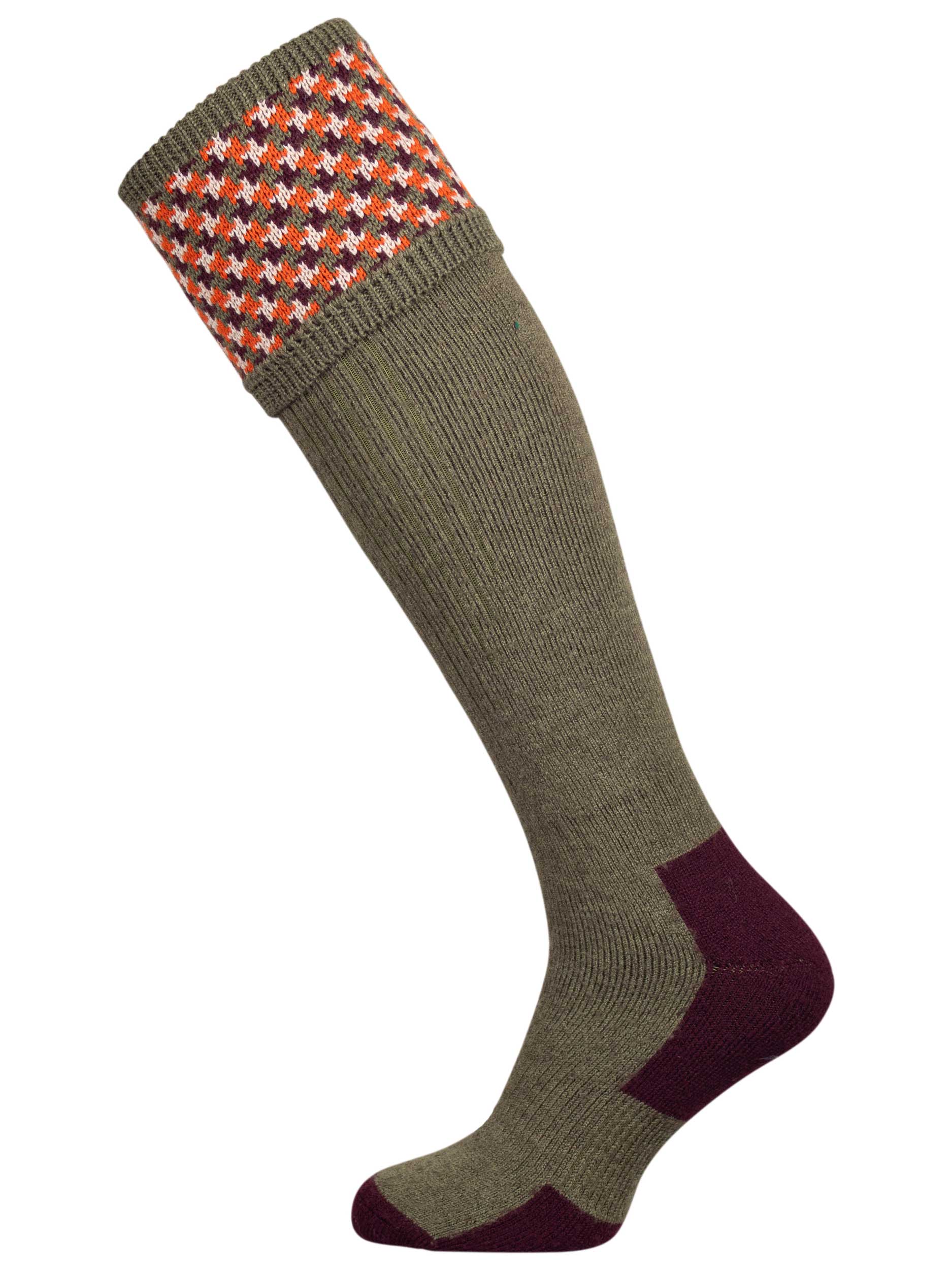 A contemporary technical shooting sock with supportive foot arch in dark olive with burgundy and orange pattern in the turnover